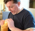 Mark sewing a button onto his book at Barnard Castle